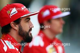 (L to R): Fernando Alonso (ESP) Ferrari and team mate Kimi Raikkonen (FIN) Ferrari at a team photograph. 21.11.2014. Formula 1 World Championship, Rd 19, Abu Dhabi Grand Prix, Yas Marina Circuit, Abu Dhabi, Practice Day.