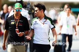 (L to R): Sergio Perez (MEX) Sahara Force India F1 with Kamui Kobayashi (JPN) Caterham. 21.11.2014. Formula 1 World Championship, Rd 19, Abu Dhabi Grand Prix, Yas Marina Circuit, Abu Dhabi, Practice Day.