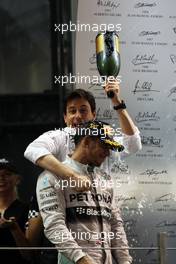 Race winner and World Champion Lewis Hamilton (GBR) Mercedes AMG F1 celebrates with Toto Wolff (GER) Mercedes AMG F1 Shareholder and Executive Director on the podium. 23.11.2014. Formula 1 World Championship, Rd 19, Abu Dhabi Grand Prix, Yas Marina Circuit, Abu Dhabi, Race Day.