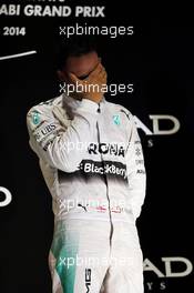Race winner and World Champion Lewis Hamilton (GBR) Mercedes AMG F1 celebrates on the podium. 23.11.2014. Formula 1 World Championship, Rd 19, Abu Dhabi Grand Prix, Yas Marina Circuit, Abu Dhabi, Race Day.