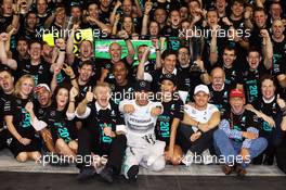 Race winner and World Champion Lewis Hamilton (GBR) Mercedes AMG F1 celebrates with the team. 23.11.2014. Formula 1 World Championship, Rd 19, Abu Dhabi Grand Prix, Yas Marina Circuit, Abu Dhabi, Race Day.
