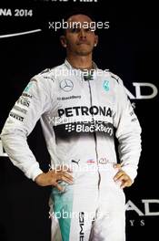 Race winner and World Champion Lewis Hamilton (GBR) Mercedes AMG F1 celebrates on the podium. 23.11.2014. Formula 1 World Championship, Rd 19, Abu Dhabi Grand Prix, Yas Marina Circuit, Abu Dhabi, Race Day.