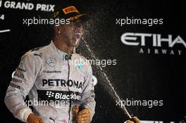 Race winner and World Championship Lewis Hamilton (GBR) Mercedes AMG F1 celebrates on the podium. 23.11.2014. Formula 1 World Championship, Rd 19, Abu Dhabi Grand Prix, Yas Marina Circuit, Abu Dhabi, Race Day.