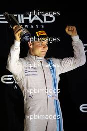 Valtteri Bottas (FIN) Williams celebrates his third position on the podium. 23.11.2014. Formula 1 World Championship, Rd 19, Abu Dhabi Grand Prix, Yas Marina Circuit, Abu Dhabi, Race Day.