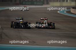 Kevin Magnussen (DEN) McLaren MP4-29 and Romain Grosjean (FRA) Lotus F1 E22 battle for position. 23.11.2014. Formula 1 World Championship, Rd 19, Abu Dhabi Grand Prix, Yas Marina Circuit, Abu Dhabi, Race Day.