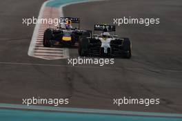 Kevin Magnussen (DEN) McLaren MP4-29 and Sebastian Vettel (GER) Red Bull Racing RB10 battle for position. 23.11.2014. Formula 1 World Championship, Rd 19, Abu Dhabi Grand Prix, Yas Marina Circuit, Abu Dhabi, Race Day.