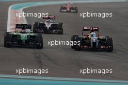 Will Stevens (GBR) Caterham CT05 and Romain Grosjean (FRA) Lotus F1 E22 battle for position. 23.11.2014. Formula 1 World Championship, Rd 19, Abu Dhabi Grand Prix, Yas Marina Circuit, Abu Dhabi, Race Day.