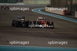Kevin Magnussen (DEN) McLaren MP4-29 and Fernando Alonso (ESP) Ferrari F14-T battle for position. 23.11.2014. Formula 1 World Championship, Rd 19, Abu Dhabi Grand Prix, Yas Marina Circuit, Abu Dhabi, Race Day.