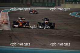 Fernando Alonso (ESP) Ferrari F14-T and Jenson Button (GBR) McLaren MP4-29 battle for position. 23.11.2014. Formula 1 World Championship, Rd 19, Abu Dhabi Grand Prix, Yas Marina Circuit, Abu Dhabi, Race Day.