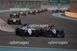 Valtteri Bottas (FIN) Williams FW36 and Daniil Kvyat (RUS) Scuderia Toro Rosso STR9 battle for position. 23.11.2014. Formula 1 World Championship, Rd 19, Abu Dhabi Grand Prix, Yas Marina Circuit, Abu Dhabi, Race Day.