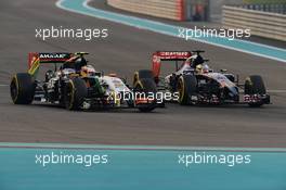 Sergio Perez (MEX) Sahara Force India F1 VJM07 and Jean-Eric Vergne (FRA) Scuderia Toro Rosso STR9 battle for position. 23.11.2014. Formula 1 World Championship, Rd 19, Abu Dhabi Grand Prix, Yas Marina Circuit, Abu Dhabi, Race Day.