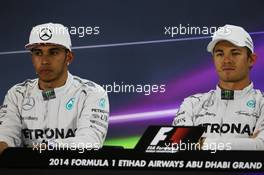 (L to R): Lewis Hamilton (GBR) Mercedes AMG F1 with team mate Nico Rosberg (GER) Mercedes AMG F1 in the FIA Press Conference. 22.11.2014. Formula 1 World Championship, Rd 19, Abu Dhabi Grand Prix, Yas Marina Circuit, Abu Dhabi, Qualifying Day.