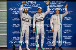 Qualifying top three in parc ferme (L to R): Lewis Hamilton (GBR) Mercedes AMG F1, second; Nico Rosberg (GER) Mercedes AMG F1, pole position; Valtteri Bottas (FIN) Williams, third. 22.11.2014. Formula 1 World Championship, Rd 19, Abu Dhabi Grand Prix, Yas Marina Circuit, Abu Dhabi, Qualifying Day.