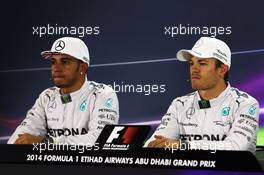 (L to R): Lewis Hamilton (GBR) Mercedes AMG F1 and team mate Nico Rosberg (GER) Mercedes AMG F1 in the FIA Press Conference. 22.11.2014. Formula 1 World Championship, Rd 19, Abu Dhabi Grand Prix, Yas Marina Circuit, Abu Dhabi, Qualifying Day.