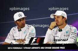 (L to R): Lewis Hamilton (GBR) Mercedes AMG F1 and team mate Nico Rosberg (GER) Mercedes AMG F1 in the FIA Press Conference. 22.11.2014. Formula 1 World Championship, Rd 19, Abu Dhabi Grand Prix, Yas Marina Circuit, Abu Dhabi, Qualifying Day.