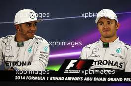 (L to R): Lewis Hamilton (GBR) Mercedes AMG F1 with team mate Nico Rosberg (GER) Mercedes AMG F1 in the FIA Press Conference. 22.11.2014. Formula 1 World Championship, Rd 19, Abu Dhabi Grand Prix, Yas Marina Circuit, Abu Dhabi, Qualifying Day.