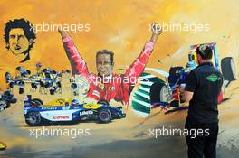 An artist paints a mural in the Fanzone area. 23.11.2014. Formula 1 World Championship, Rd 19, Abu Dhabi Grand Prix, Yas Marina Circuit, Abu Dhabi, Race Day.