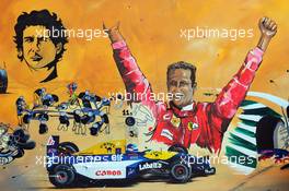 An artist paints a mural in the Fanzone area. 23.11.2014. Formula 1 World Championship, Rd 19, Abu Dhabi Grand Prix, Yas Marina Circuit, Abu Dhabi, Race Day.