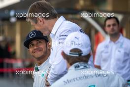 Lewis Hamilton (GBR) Mercedes AMG F1 with Thomas Weber (GER) Member of the Board of Management of Daimler AG at a team photograph. 23.11.2014. Formula 1 World Championship, Rd 19, Abu Dhabi Grand Prix, Yas Marina Circuit, Abu Dhabi, Race Day.