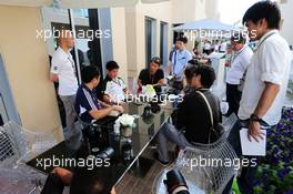 Kamui Kobayashi (JPN) Caterham with the media. 20.11.2014. Formula 1 World Championship, Rd 19, Abu Dhabi Grand Prix, Yas Marina Circuit, Abu Dhabi, Preparation Day.
