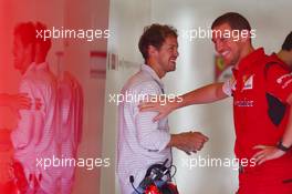 Sebastian Vettel (GER) with Renato Bisignani (ITA) Ferrari Head of Communications. 25.11.2014. Formula 1 Testing, Day One, Yas Marina Circuit, Abu Dhabi, Tuesday.