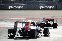 Romain Grosjean (FRA) Lotus F1 E22 leads Sebastian Vettel (GER) Red Bull Racing RB10. 02.11.2014. Formula 1 World Championship, Rd 17, United States Grand Prix, Austin, Texas, USA, Race Day.