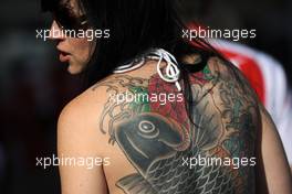 A woman with a tattoo of a fish on her back. 02.11.2014. Formula 1 World Championship, Rd 17, United States Grand Prix, Austin, Texas, USA, Race Day.