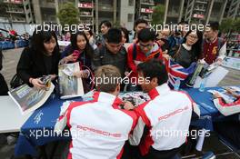 Mark Webber (AUS) (Right) #20 Porsche Team Porsche 919 Hybrid, signs autographs for the fans. 02.11.2014. FIA World Endurance Championship, Round 6, Six Hours of Shanghai, Shanghai, China, Sunday.
