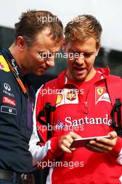 (L to R): Ole Schack (DEN) Red Bull Racing Mechanic with Sebastian Vettel (GER) Ferrari. 19.06.2015. Formula 1 World Championship, Rd 8, Austrian Grand Prix, Spielberg, Austria, Practice Day.