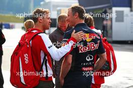 (L to R): Sebastian Vettel (GER) Ferrari with Ole Schack (DEN) Red Bull Racing Mechanic. 19.06.2015. Formula 1 World Championship, Rd 8, Austrian Grand Prix, Spielberg, Austria, Practice Day.