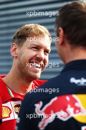 (L to R): Sebastian Vettel (GER) Ferrari with Ole Schack (DEN) Red Bull Racing Mechanic. 19.06.2015. Formula 1 World Championship, Rd 8, Austrian Grand Prix, Spielberg, Austria, Practice Day.