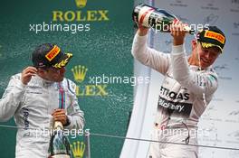 Race winner Nico Rosberg (GER) Mercedes AMG F1 celebrates with the champagne with Felipe Massa (BRA) Williams (Left) on the podium. 21.06.2015. Formula 1 World Championship, Rd 8, Austrian Grand Prix, Spielberg, Austria, Race Day.