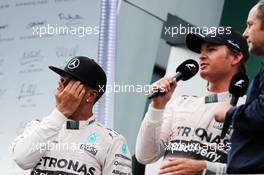 (L to R): Lewis Hamilton (GBR) Mercedes AMG F1 with race winner Nico Rosberg (GER) Mercedes AMG F1 and Gerhard Berger (AUT) on the podium. 21.06.2015. Formula 1 World Championship, Rd 8, Austrian Grand Prix, Spielberg, Austria, Race Day.