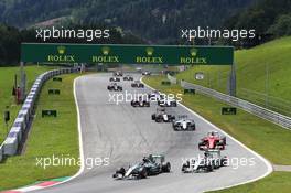 Nico Rosberg (GER) Mercedes AMG F1 W06 leads team mate Lewis Hamilton (GBR) Mercedes AMG F1 W06 at the start of the race. 21.06.2015. Formula 1 World Championship, Rd 8, Austrian Grand Prix, Spielberg, Austria, Race Day.