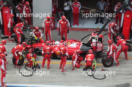 Sebastian Vettel (GER) Ferrari SF15-T has a long pit stop with a stuck rear right wheel. 21.06.2015. Formula 1 World Championship, Rd 8, Austrian Grand Prix, Spielberg, Austria, Race Day.