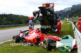 Marshals remove the start crash involving Fernando Alonso (ESP) McLaren MP4-30 and Kimi Raikkonen (FIN) Ferrari SF15-T. 21.06.2015. Formula 1 World Championship, Rd 8, Austrian Grand Prix, Spielberg, Austria, Race Day.