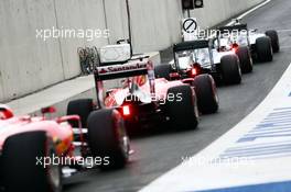 Nico Rosberg (GER) Mercedes AMG F1 W06; Lewis Hamilton (GBR) Mercedes AMG F1 W06; Sebastian Vettel (GER) Ferrari SF15-T; and Kimi Raikkonen (FIN) Ferrari SF15-T at the end of the pit lane. 20.06.2015. Formula 1 World Championship, Rd 8, Austrian Grand Prix, Spielberg, Austria, Qualifying Day.