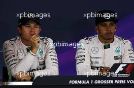 (L to R): Nico Rosberg (GER) Mercedes AMG F1 and team mate Lewis Hamilton (GBR) Mercedes AMG F1 in the FIA Press Conference. 20.06.2015. Formula 1 World Championship, Rd 8, Austrian Grand Prix, Spielberg, Austria, Qualifying Day.