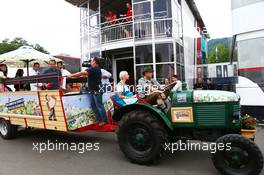 A local Spielberg tractor pulls up outside the Manor Marussia F1 Team motorhome. 18.06.2015. Formula 1 World Championship, Rd 8, Austrian Grand Prix, Spielberg, Austria, Preparation Day.