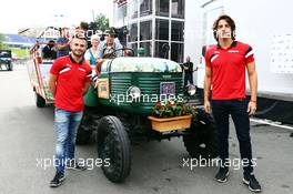 (L to R): Will Stevens (GBR) Manor Marussia F1 Team and Roberto Merhi (ESP) Manor Marussia F1 Team with local Spielberg hospitality. 18.06.2015. Formula 1 World Championship, Rd 8, Austrian Grand Prix, Spielberg, Austria, Preparation Day.