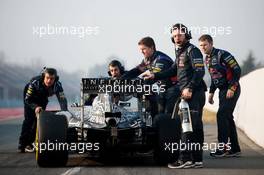 Daniel Ricciardo (AUS) Red Bull Racing RB11 is pushed back down the pit lane by mechanics. 20.02.2015. Formula One Testing, Day Two, Barcelona, Spain.