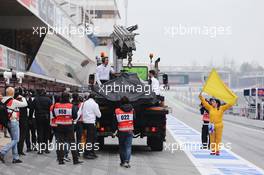 The McLaren MP4-30 of Jenson Button (GBR) McLaren is recovered back to the pits on the back of a truck. 21.02.2015. Formula One Testing, Day Three, Barcelona, Spain.