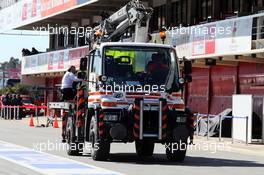 The McLaren MP4-30 of Fernando Alonso (ESP) McLaren is recovered back to the pits on the back of a truck. 22.02.2015. Formula One Testing, Day Four, Barcelona, Spain.