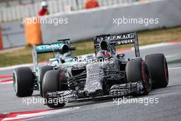 Daniil Kvyat (RUS) Red Bull Racing RB11 leads Nico Rosberg (GER) Mercedes AMG F1 W06. 27.02.2015. Formula One Testing, Day Two, Barcelona, Spain.