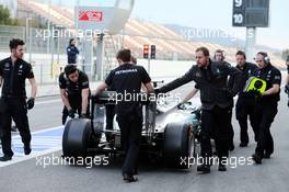The Mercedes AMG F1 W06 of Lewis Hamilton (GBR) Mercedes AMG F1 is pushed back down the pit lane by mechanics. 28.02.2015. Formula One Testing, Day Three, Barcelona, Spain.