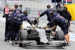 The Red Bull Racing RB11 of Daniel Ricciardo (AUS) Red Bull Racing RB11 is pushed down the pit lane by mechanics. 01.03.2015. Formula One Testing, Day Four, Barcelona, Spain.