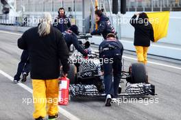 Daniil Kvyat (RUS) Red Bull Racing RB11 is pushed back down the pit lane by mechanics. 26.02.2015. Formula One Testing, Day One, Barcelona, Spain.