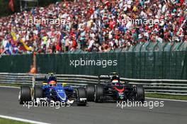 Felipe Nasr (BRA) Sauber C34 and Jenson Button (GBR) McLaren MP4-30 battle for position. 23.08.2015. Formula 1 World Championship, Rd 13, Belgian Grand Prix, Spa Francorchamps, Belgium, Race Day.