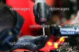 McLaren MP4-30 worked on with a drill by a mechanic. 22.08.2015. Formula 1 World Championship, Rd 11, Belgian Grand Prix, Spa Francorchamps, Belgium, Qualifying Day.