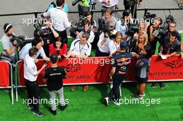 (L to R): Lewis Hamilton (GBR) Mercedes AMG F1 and Daniil Kvyat (RUS) Red Bull Racing with the media. 20.08.2015. Formula 1 World Championship, Rd 11, Belgian Grand Prix, Spa Francorchamps, Belgium, Preparation Day.